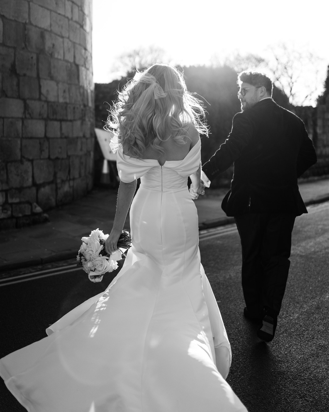 A winter city wedding in York, styled with intention.
 Crisp blue skies, black tie tailoring, and a dress that feels quietly iconic; proof that town hall weddings are no longer understated, but unapologetically chic.This style of celebration is having a moment: intimate, fashion-led, and centred on the couple rather than tradition. Whether in York, Marylebone Town Hall, or Chelsea Town Hall, city weddings like this prioritise elegance, simplicity, and imagery that feels timeless yet completely current.Bride @haguey27
Groom @craigo_mt
Venue @pearlycowyork @guesthousehotels
Ceremony @yorkregisteroffice
Dress @marytrufel_dubai
Suit @suitsupply
Hair & Makeup @sonia.rosa.mua
Florals @thewildarrangement
Shoes @manoloblahnik
Bag @pradaTown hall wedding photographer UK Marylebone Town Hall wedding inspiration Chelsea Town Hall wedding photographer Editorial city wedding photography Chic and modern wedding style